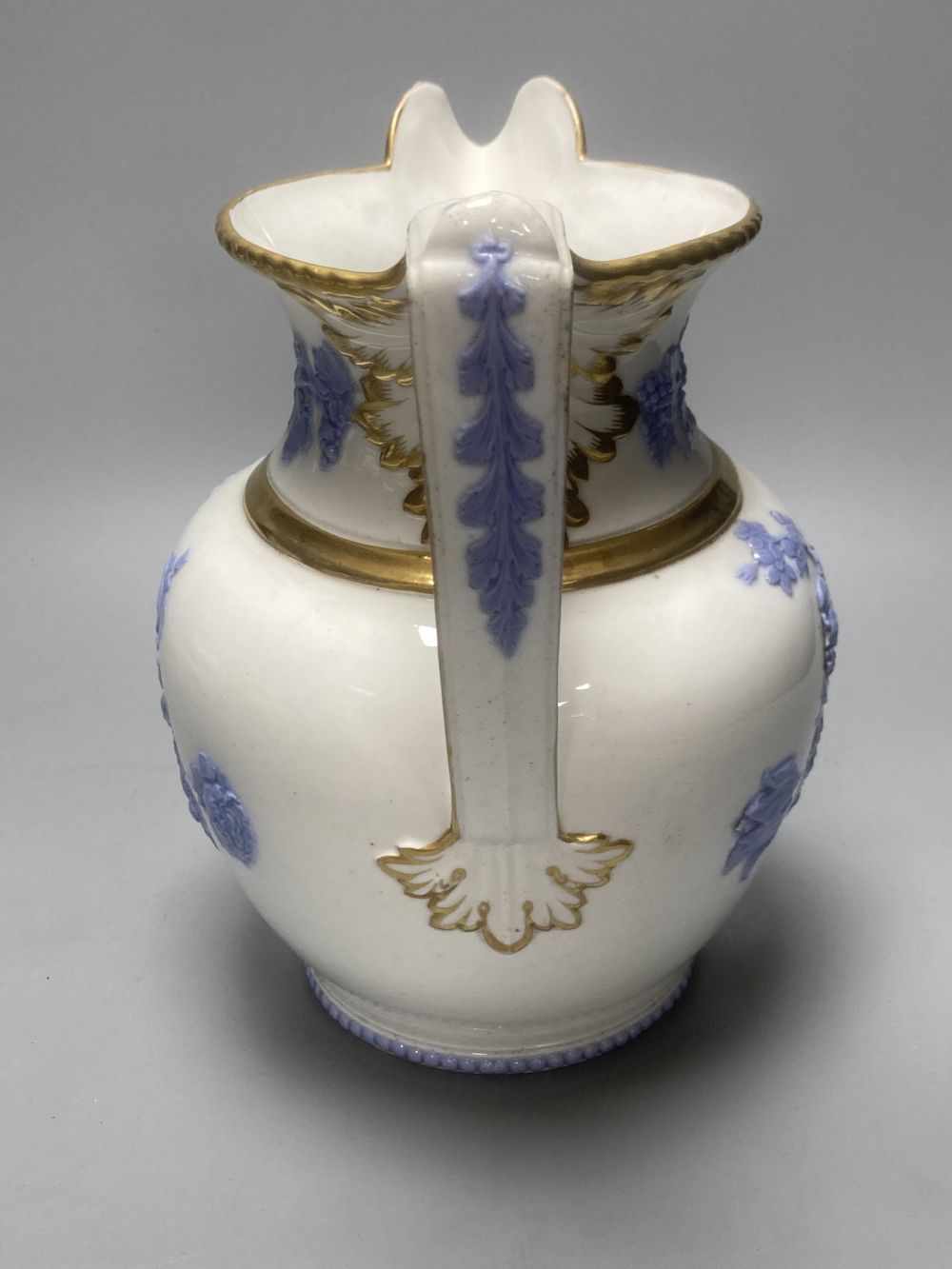 Four early 19th century Staffordshire jugs, each with lilac coloured floral applied panels, one dated 1826, tallest 22cm